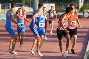 DENIZLI, TURKIYE - JULY 17, 2022: Athletes running 4x400 metres relay during Balkan Athletics U20 Championships in Denizli Albayrak Athletics Track clipart