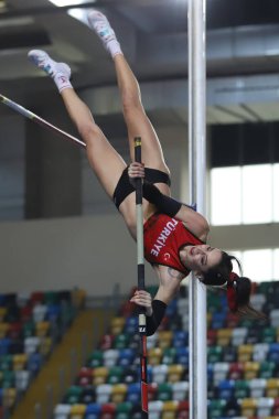 ISTANBUL, TURKEY - MARCH 05, 2022: Undefined athlete pole vaulting during Balkan Athletics Indoor Championships in Atakoy Athletics Arena