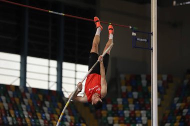 ISTANBUL, TURKEY - MARCH 05, 2022: Undefined athlete pole vaulting during Balkan Athletics Indoor Championships in Atakoy Athletics Arena
