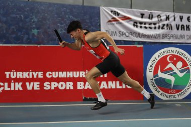 ISTANBUL, TURKEY - MARCH 05, 2022: Undefined athlete running 4x400 metres relay during Balkan Athletics Indoor Championships in Atakoy Athletics Arena