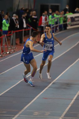 ISTANBUL, TURKEY - MARCH 05, 2022: Athletes running 4x400 metres relay during Balkan Athletics Indoor Championships in Atakoy Athletics Arena