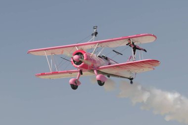 ESKISEHIR, TURKIYE - SEPTEMBER 18, 2022: Boeing PT-13D Kaydet (75-5099) Wing walking show display in Sivrihisar SHG Airshow