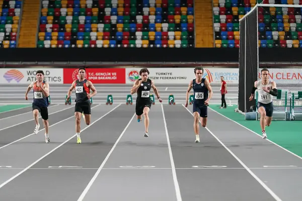 stock image ISTANBUL, TURKIYE - FEBRUARY 17, 2024: Athletes running 60 metres during Turkish Indoor Athletics Championships in Atakoy Athletics Arena