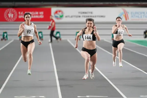 stock image ISTANBUL, TURKIYE - FEBRUARY 17, 2024: Athletes running 60 metres during Turkish Indoor Athletics Championships in Atakoy Athletics Arena