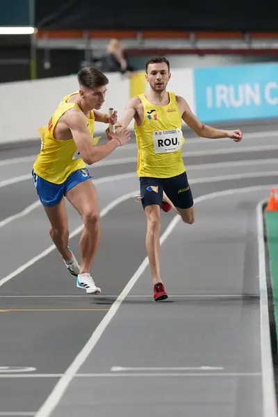 stock image ISTANBUL, TURKIYE - FEBRUARY 10, 2024: Athletes running 4x400 metres relay during Balkan Athletics Championships in Atakoy Athletics Arena