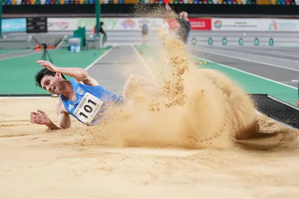 stock image ISTANBUL, TURKIYE - FEBRUARY 10, 2024: Undefined athlete triple jumping during Balkan Athletics Championships in Atakoy Athletics Arena