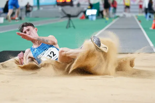 stock image ISTANBUL, TURKIYE - FEBRUARY 10, 2024: Undefined athlete triple jumping during Balkan Athletics Championships in Atakoy Athletics Arena