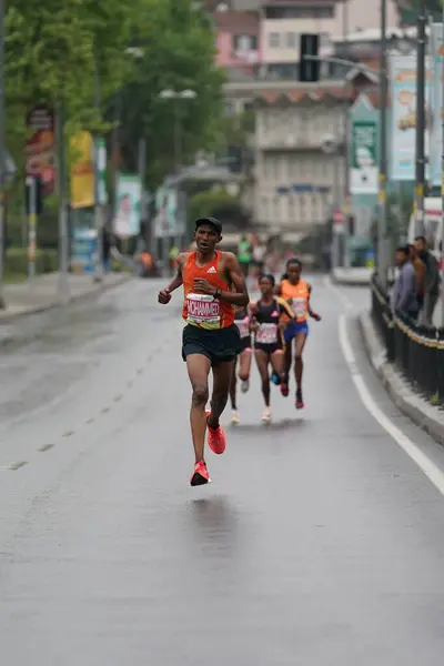 stock image ISTANBUL, TURKIYE - APRIL 28, 2024: Athletes running Istanbul half marathon in historic street of Fener district