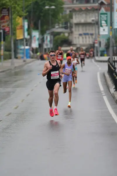 stock image ISTANBUL, TURKIYE - APRIL 28, 2024: Athletes running Istanbul half marathon in historic street of Fener district