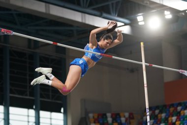 ISTANBUL, TURKIYE - FEBRUARY 10, 2024: Undefined athlete pole vaulting during Balkan Athletics Championships in Atakoy Athletics Arena clipart