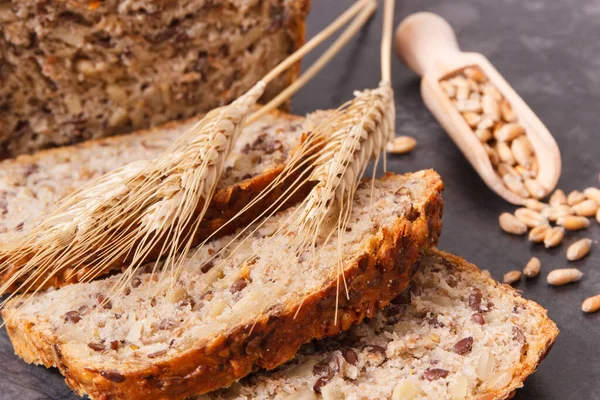 stock image Loaf of fresh baked wholegrain bread for breakfast and ears of rye or wheat grain