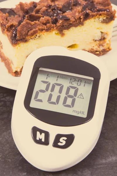 Glucose meter with high and bad result of measurement sugar level and fresh baked cheesecake. Dieting during diabetes