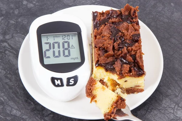 Glucose meter with high and bad result of measurement sugar level and fresh baked cheesecake. Dieting during diabetes