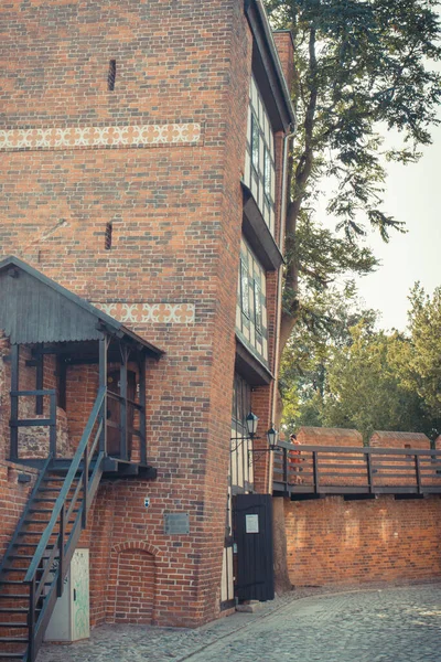 stock image Torun, Poland - August 19, 2022: View on old historic leaning tower in center of polish city Torun. Historic attraction to visit. Vintage photo