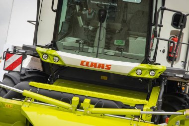 Bednary, Poland - September 25, 2021: Agroshow. Front of combine harvester with Claas logo. Manufacturer of agricultural and industrial equipment