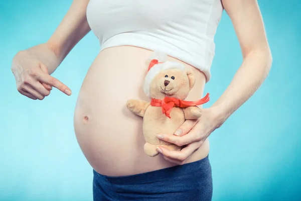 stock image Pregnant woman holding fluffy teddy bear for her expected child. Expecting for newborn. Extending family. Motherhood