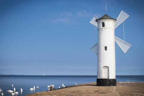 stock image Swinoujscie, West Pomeranian - Poland - June 8, 2022: View on windmill Stawa Mlyny. Charateristic navigational mark and lighthouse. Tourist attraction