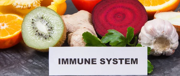 Inscription immune system with fresh ripe fruits and vegetables. Source natural vitamins, minerals and dietary fiber