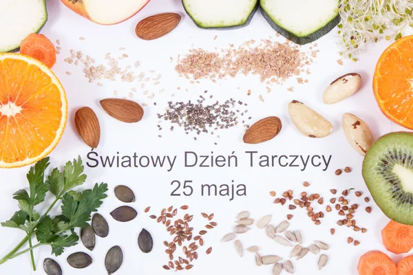 Nutritious ingredients and polish inscription World Thyroid Day 25 May on white background. Healthy food containing vitamins. Problems with thyroid concept