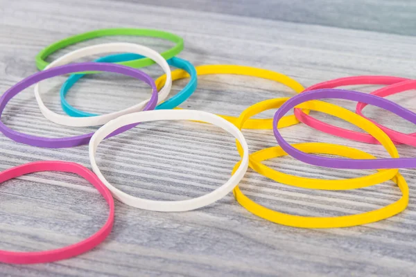 Colorful rubber bands or erasers. Development of kids motor skills, coordination, creativity and logical thinking