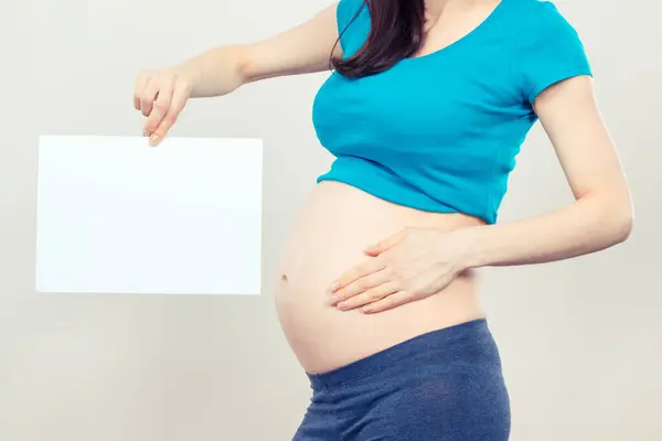 Pregnant Woman Holding Empty White Card Text Expecting Newborn Extending Royalty Free Stock Images