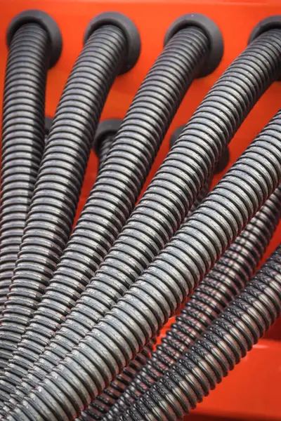 Plastic corrugated pipes in agricultural or industrial machinery. Part of hydraulic or pneumatic equipments