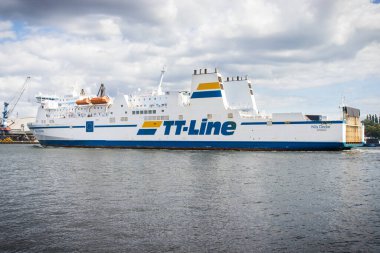 Swinoujscie, West Pomeranian - Poland - July 15, 2022: View on TT-Line Nils Dacke ferry leaving port in Swinoujscie and sailing to Trelleborg. Transport passengers and cars clipart