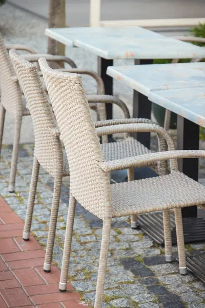 Şehir merkezindeki açık hava restoranında ya da kafede hasır ya da rattan sandalyeler ve masalar. Rahatlama zamanı.