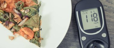 Glukometre, ölçüm şeker seviyesi ve taze pişmiş vejetaryen pizzanın sonucu. Diyabet konsepti sırasında besin