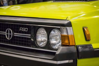 Poznan, Poland - October 07, 2023: Retro Motor Show. International Fair in Poznan. View on front of shiny old classic FSO Polonez. Detail and part of vehicle clipart