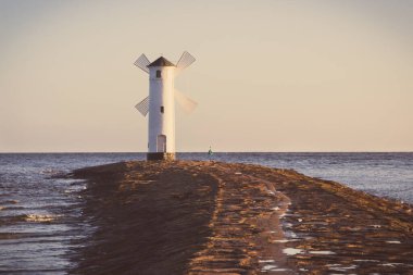 Swinoujscie, West Pomeranian - Poland - June 14, 2021: View on windmill Stawa Mlyny. Charateristic navigational mark. Vintage photo clipart