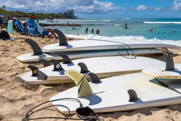 stock image Surfboards showing fins and leash ankle straps lying on the sand at Waikiki beach in Honolulu Hawaii. Defocused background.