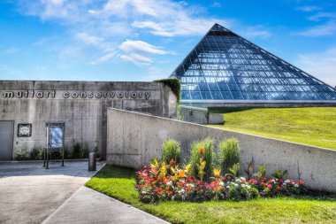 EDMONTON, CANADA - JULY 8, 2014: The Muttart Conservatory is a popular botanical garden located in the North Saskatchewan river valley of the capital of Alberta, Canada. clipart