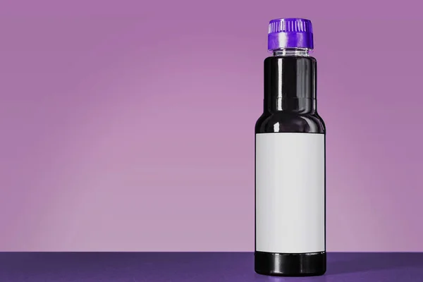 soy sauce bottle mock up standing on a black table against the purple background with copy space