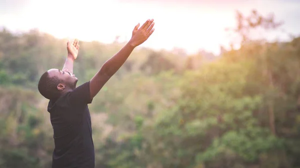 stock image Freedom African man standing in nature forest and lake with smile and happiness.Concept about nature fertility and relaxation