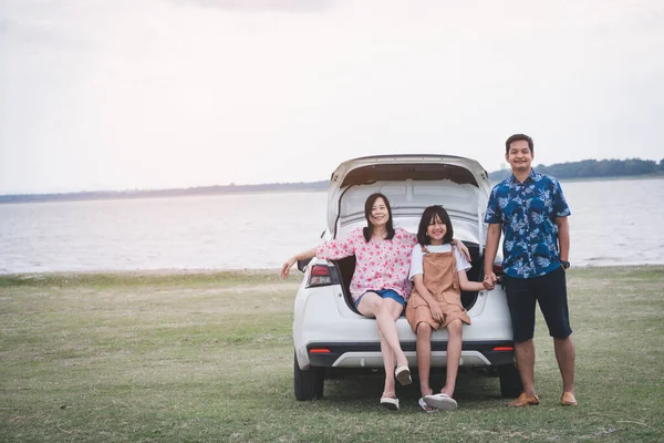 Happy family traveling on holiday by car. Parents and daughter spend free time together.