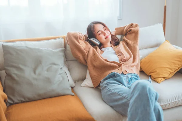 Happy Asian Woman Listening Music Mobile Phone While Sitting Sofa — Foto de Stock