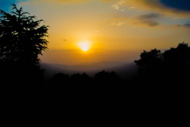 Lansdowne dağlarından gün batımı manzarası. Lansdowne 'daki Mountain Sunset Manzarası. Orman yolunda inanılmaz altın gün batımı, Lansdowne Uttarakhand.