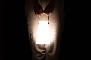 woman hands holding big electric lantern at night, electricity deficiency concept, blackout, energy safe hand torch clipart