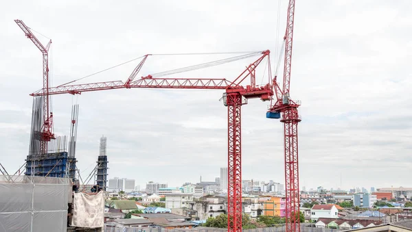 View of the construction site and red cranes for building modern residential area, construction concept for the developed city.