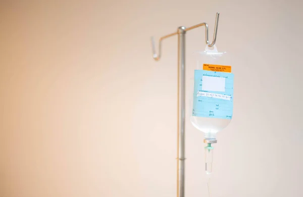 The saline bag hanging on the IV pole in emergency room at hospital.