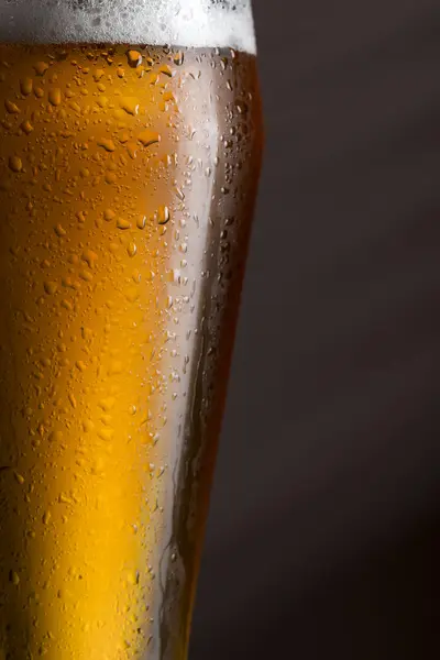 Detail of a wet glass of cold light beer