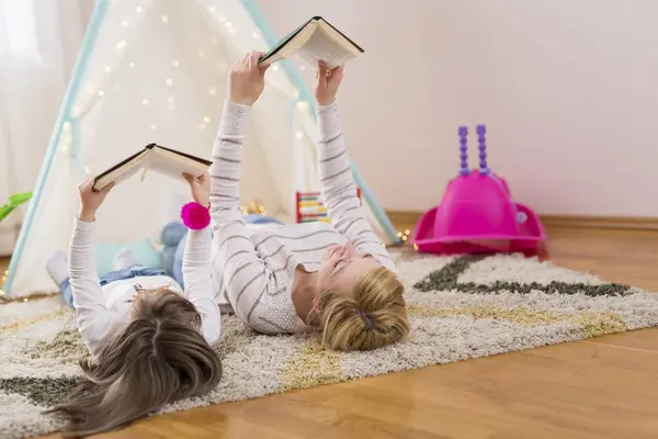 Mother Daughter Lying Playroom Floor Reading Books Focus Mother — Stock Photo, Image