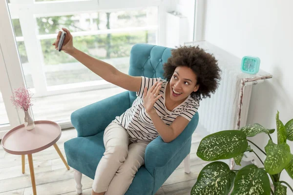 Genç Melez Kadın Koltukta Oturuyor Akıllı Telefonuyla Selfie Çekiyor Evde — Stok fotoğraf