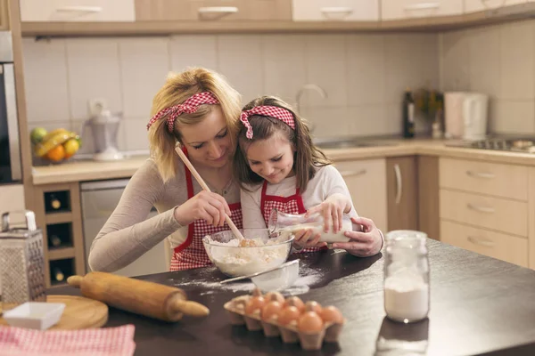 Beautiful Mother Daughter Having Fun Kitchen Daughter Pouring Milk While — Stock Photo, Image