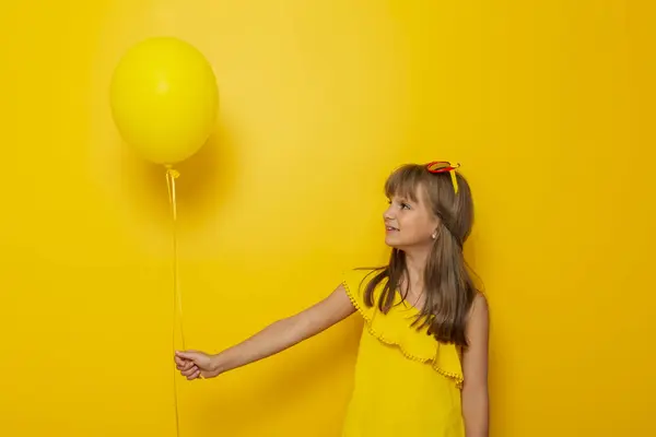 Portret Pięknej Dziewczynki Trzymającej Żółty Balon Żółtym Tle — Zdjęcie stockowe