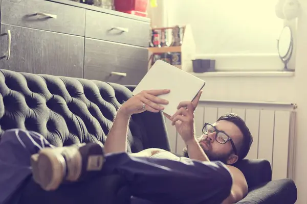 Male Model Lying Couch Living Room Surfing Web Tablet Computer — Stock Photo, Image