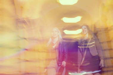 Şehir sokaklarında yürüyen iki kız, arkadaşlarıyla bir gece geçirmeye hazır.