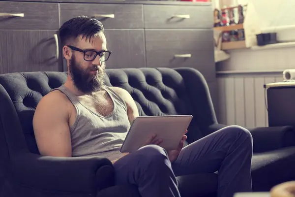 Male Model Sitting Couch Living Room Surfing Web Tablet Computer — Stock Photo, Image
