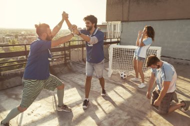 Bir grup genç arkadaş çatıdaki terasta futbol oynarken eğleniyor, takımı kazanıyor gol atıyor, kaybedenler yas tutarken beşlik çakıyor.